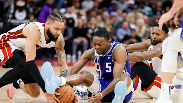 Feb 26, 2024; Sacramento, California, USA; Sacramento Kings guard De'Aaron Fox (5) and Miami Heat forward Caleb Martin (16) fight for the ball during the fourth quarter at Golden 1 Center. Mandatory Credit: Sergio Estrada-USA TODAY Sports  